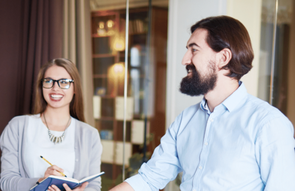 colleagues smiling discussing in officewear