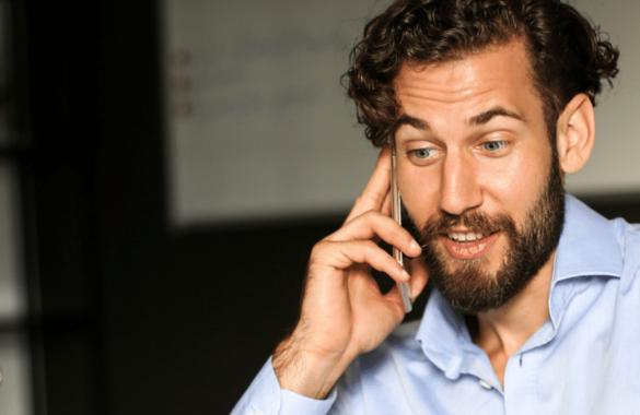 Man speaking on phone in blue shirt